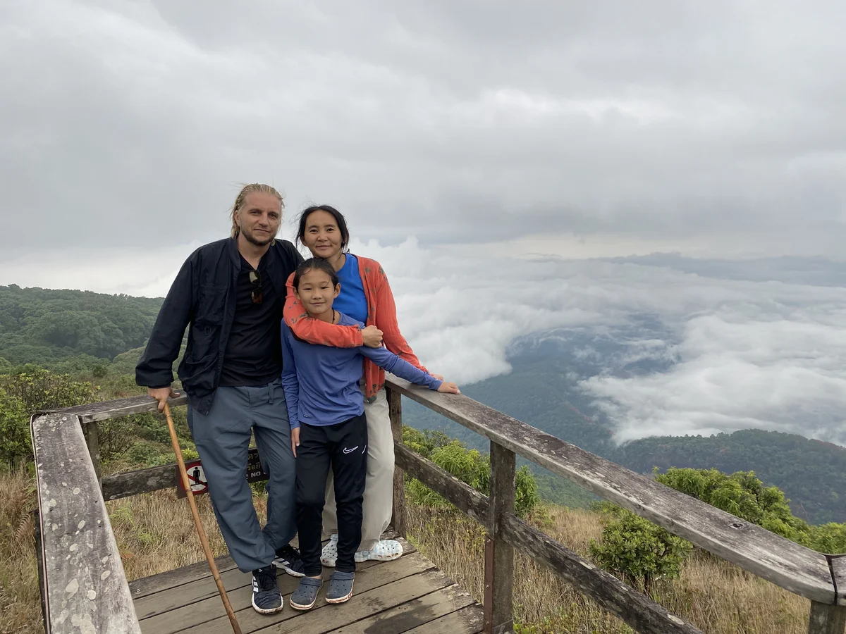 Our family of three together at a mountain viewpoint above the clouds