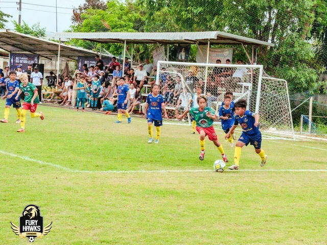 Young Fury Hawks players on the football pitch near a goal