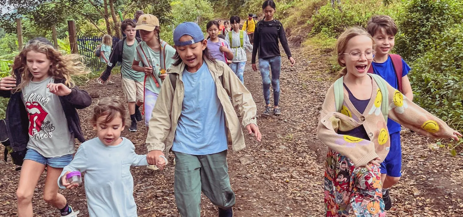 Children walking together on a forest trail during a Beaver Club outdoor adventure