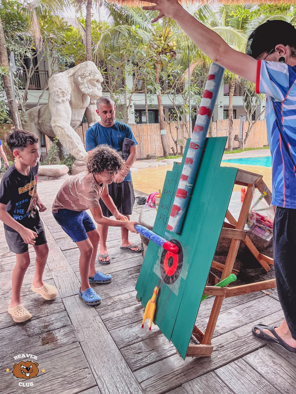 Children taking turns at a colourful carnival-style hammer game