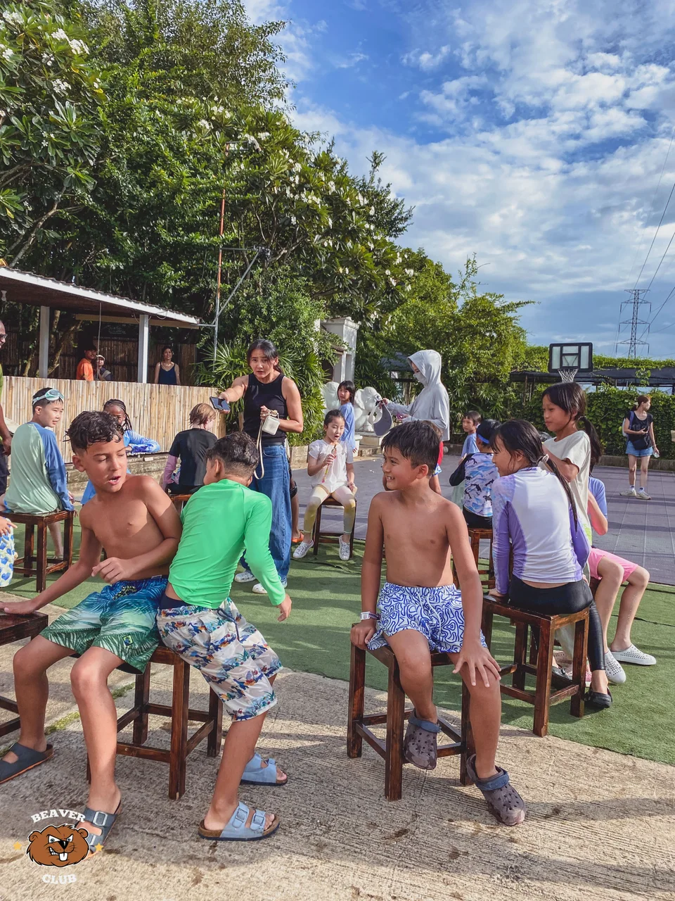 Children playing musical chairs beside the sports field at Beaver Club