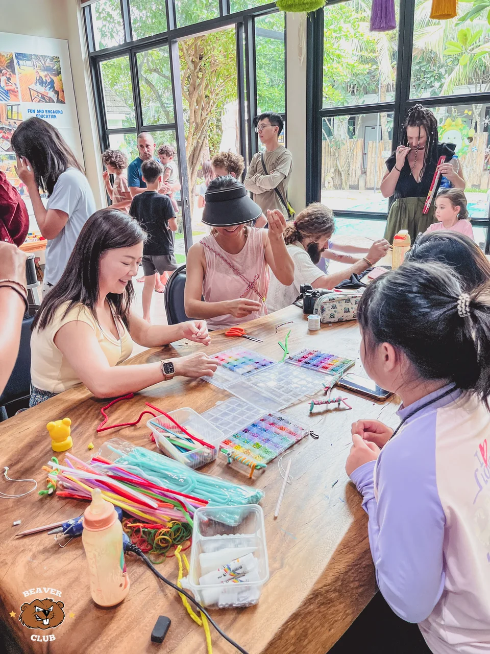 Parents and children drawing and painting together around a shared table