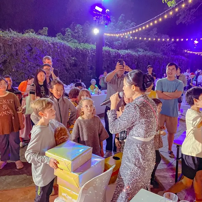 Children and adults playing party games together during a New Year celebration