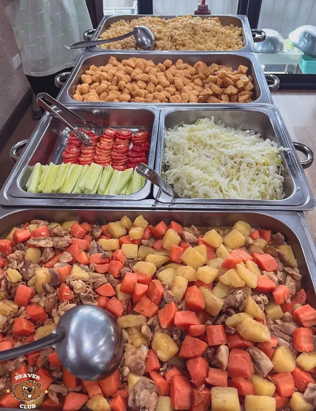 Lunch buffet with fruit, vegetables and cooked dishes at camp