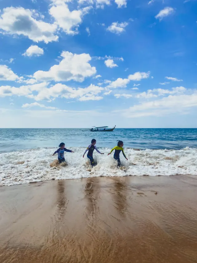 Children walking into the sea on an island trip