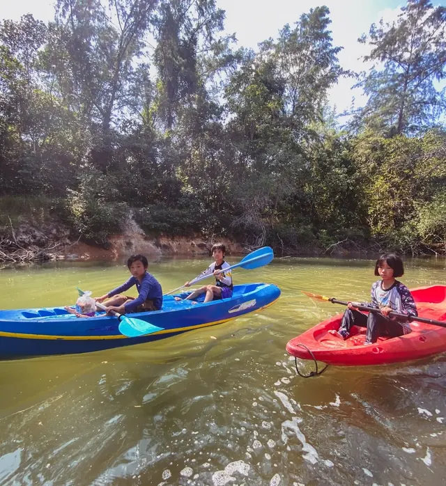 Children kayaking on calm water