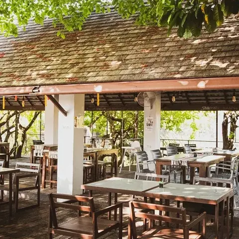 Shaded outdoor café and seating at Beaver Club