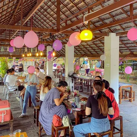 Families sitting together in the decorated covered lounge