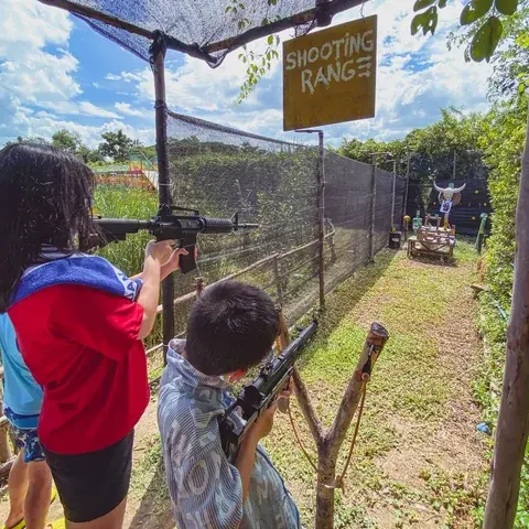Children at the netted outdoor shooting range