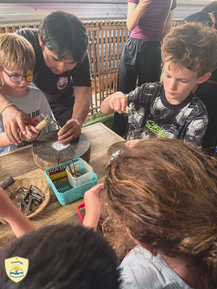 Children using small tools and materials together at a craft table